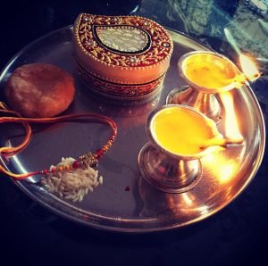 Pooja plate with lamp, rakhi and sweets blog post Akshata Shanbhag